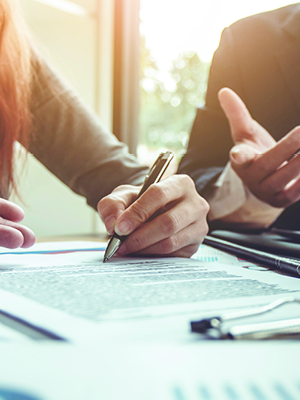 2 people signing a business document