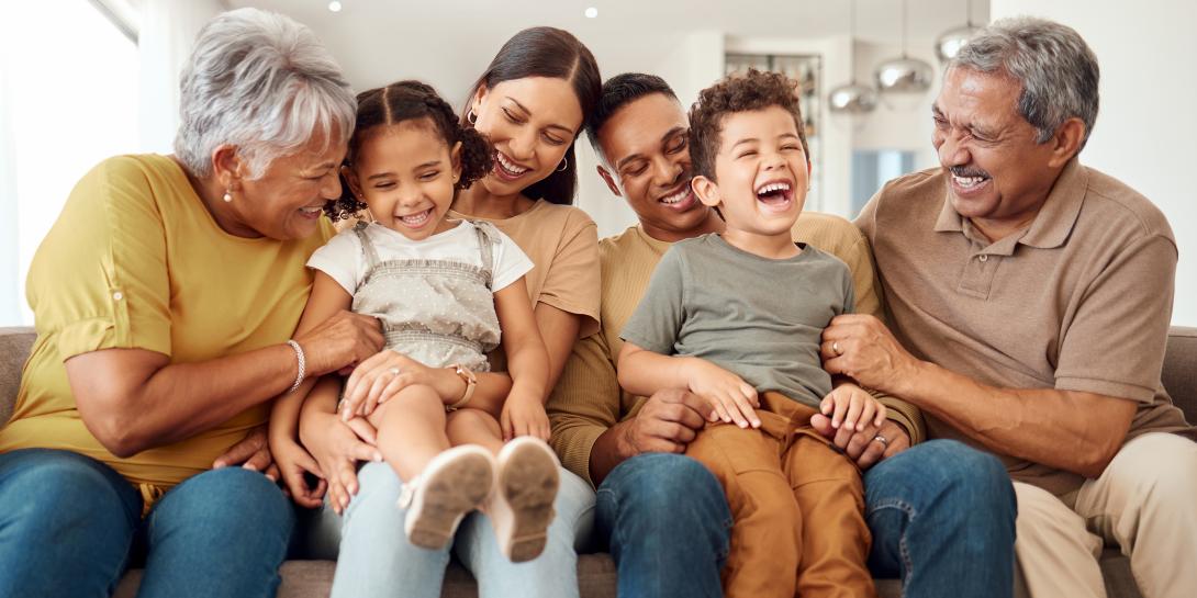 family laughing on the couch together