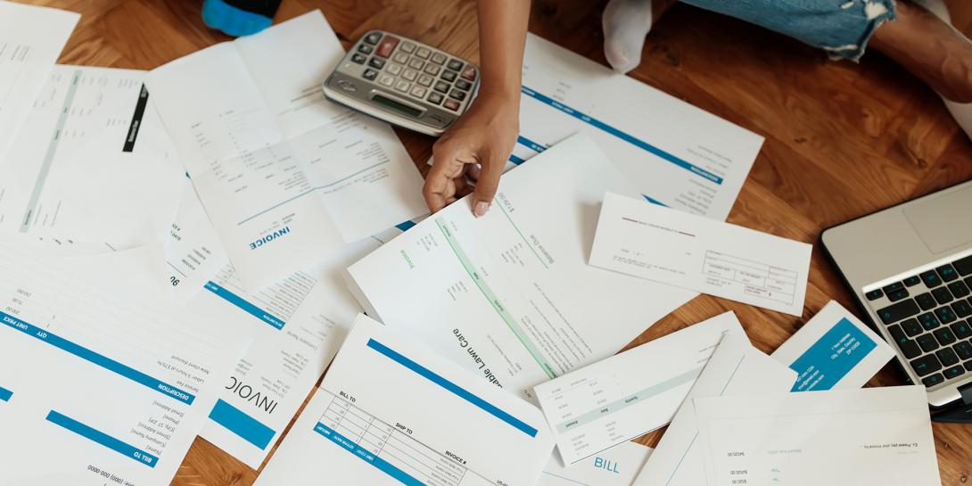 someone looking at a pile of papers